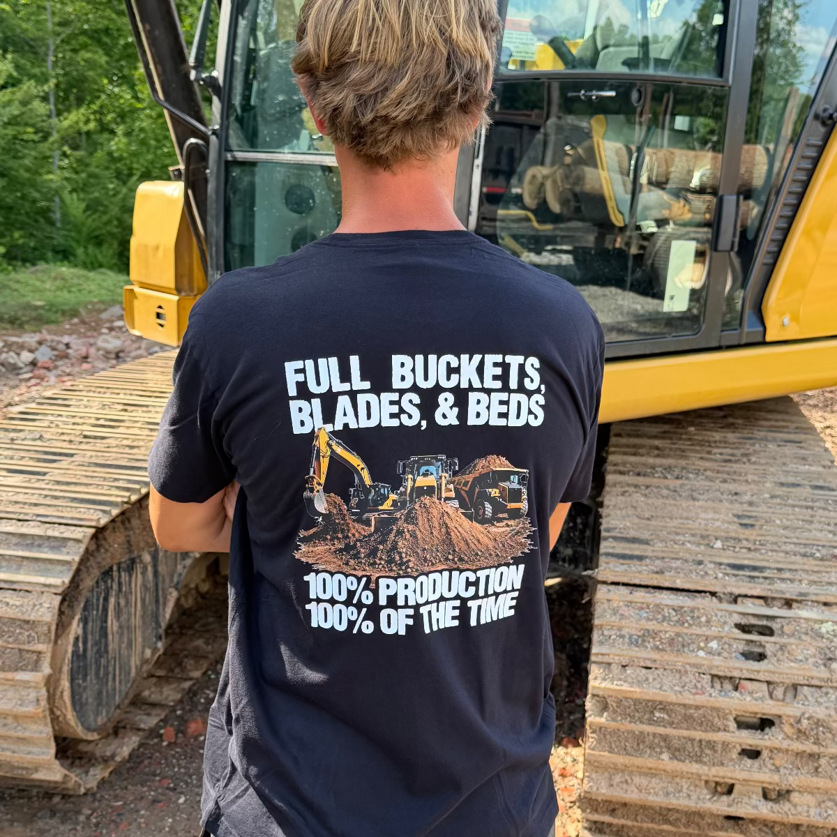 Back of Shirt Reads "Back of Full Buckets, Blades & Beds" "100% Production 100% of the time"